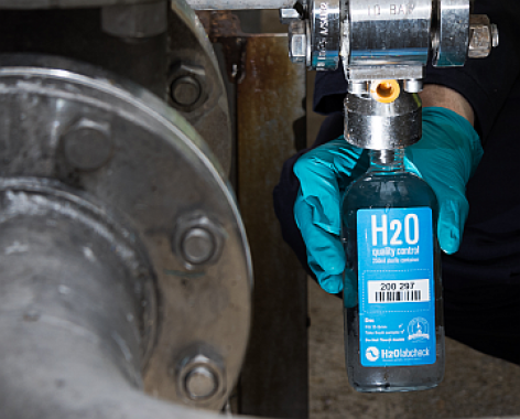 H2Olabcheck Sampling Bottle, Industrial equipment in the backgroung